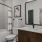 bathroom with a shower and large mirror