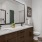 bathroom with a large mirror and closet in the background