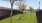 outdoor dog park with trees and a fence