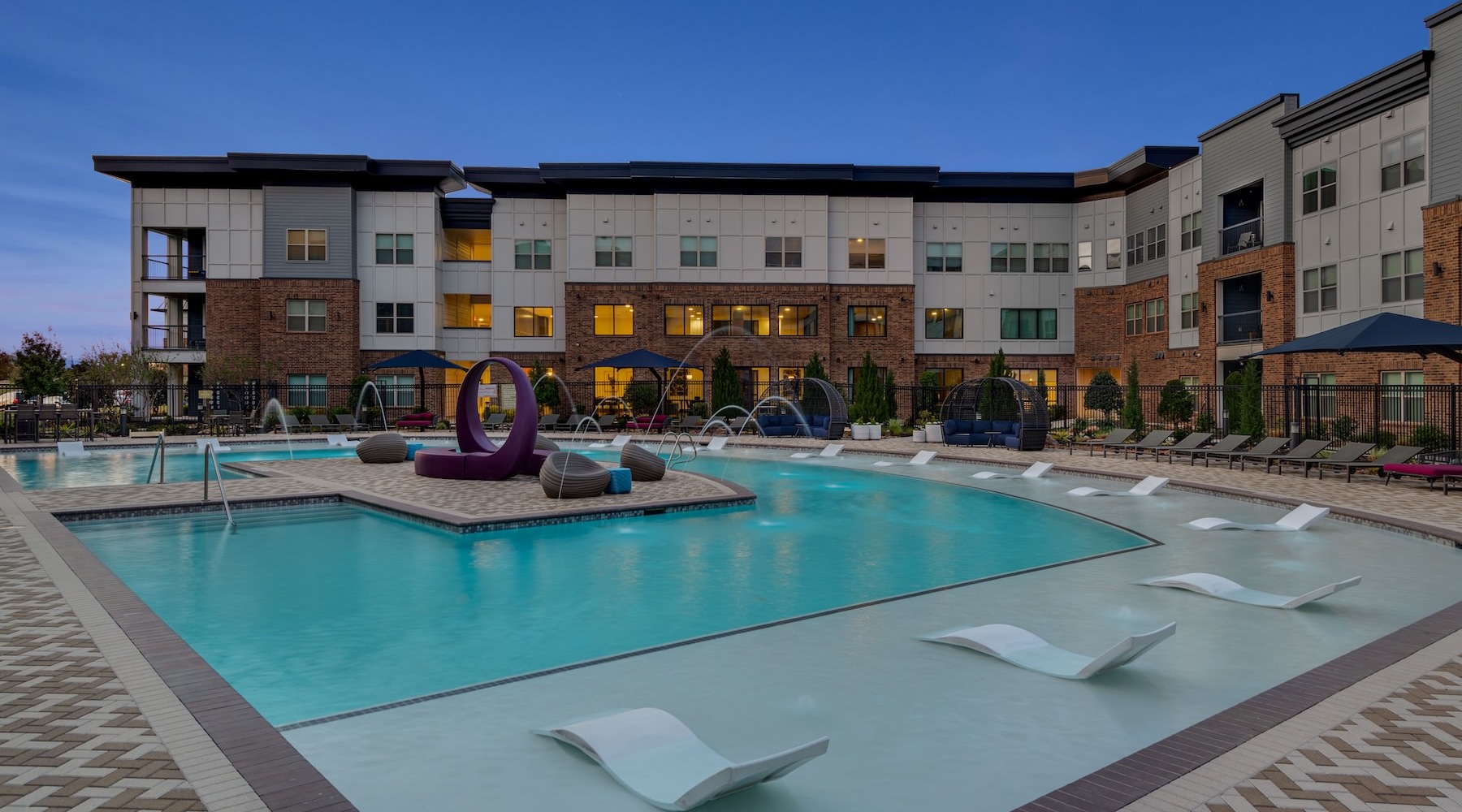 Shimmering resort-style pool swimming pool in a courtyard